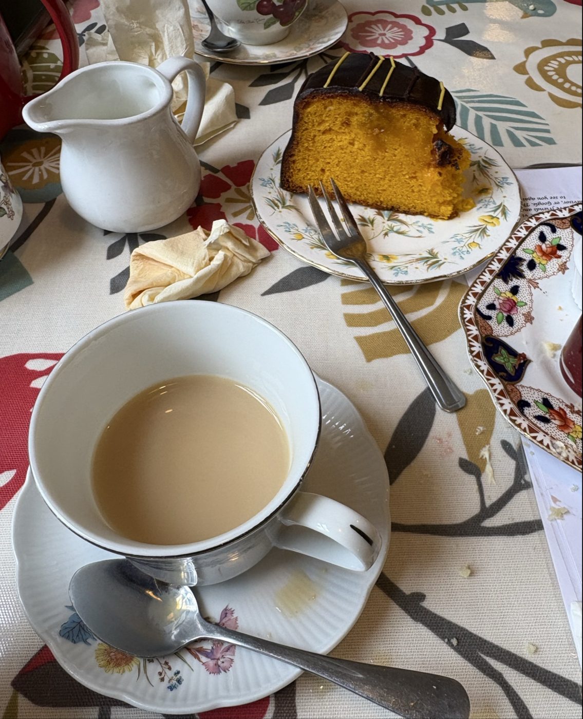 A cup of tea and a slice of orange cake